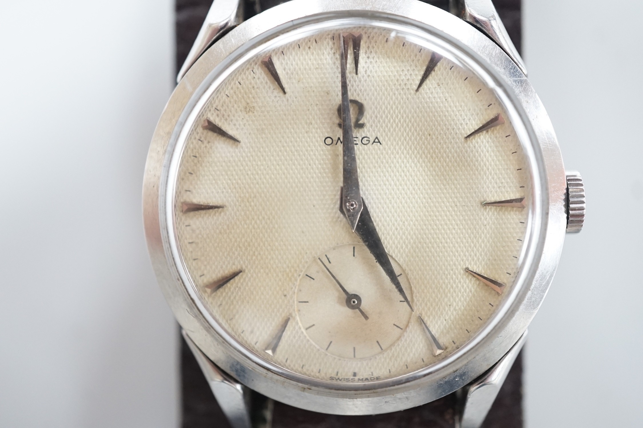 A gentleman's early 1950's stainless steel Omega wrist watch, with baton numerals and subsidiary seconds, movement c.266, on associated leather strap, case diameter 36mm.